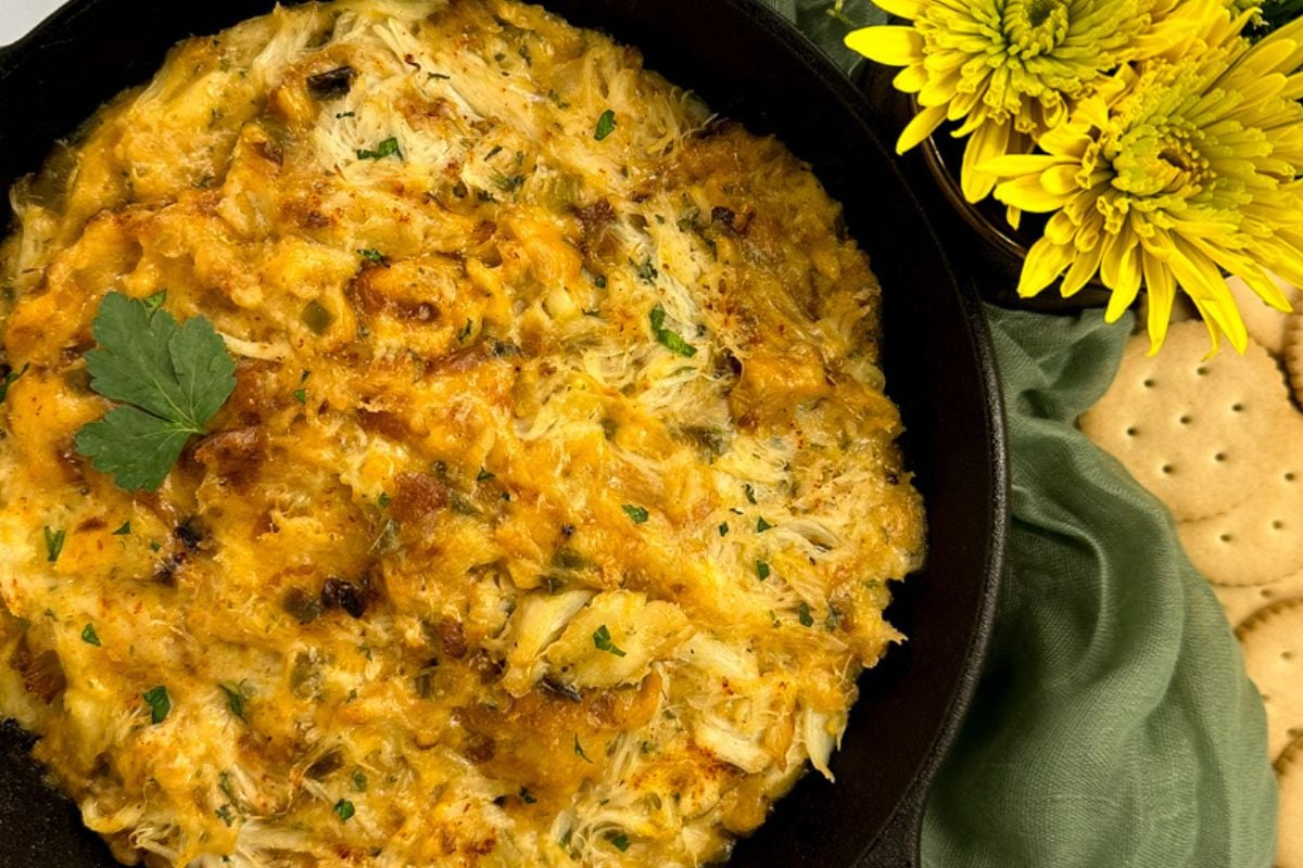Cajun crab au gratin in a small black cast iron Dutch oven.