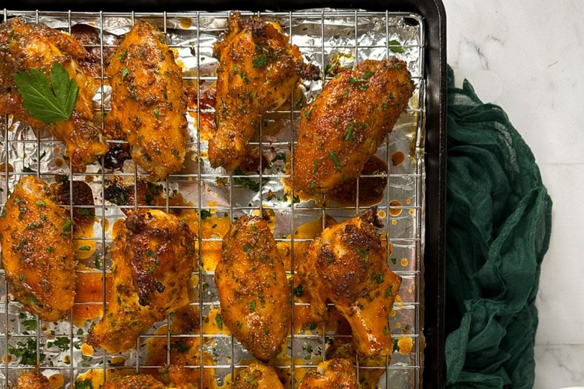 Cajun chicken wings on a baking rack.