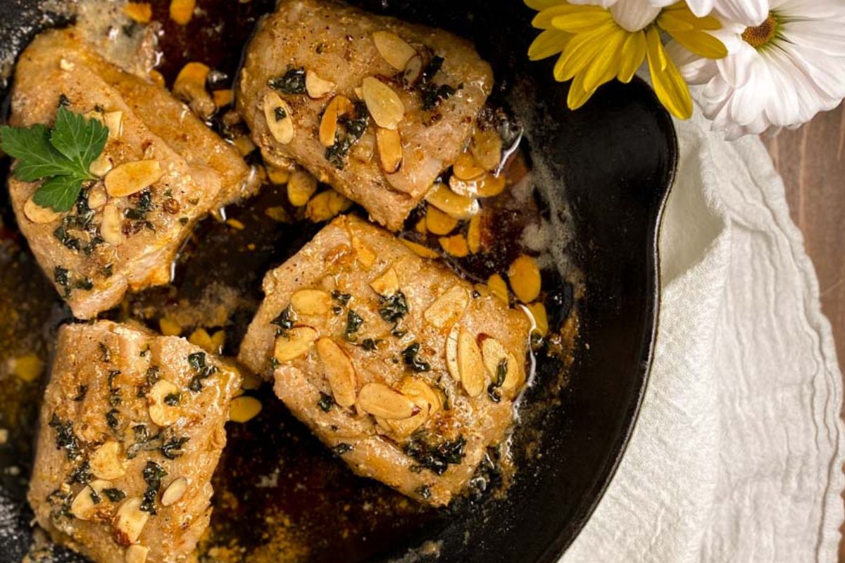 Pan-seared grouper in a skillet.