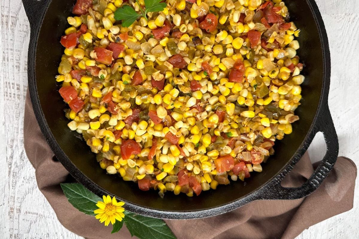 Corn maque choux in a cast iron skillet.