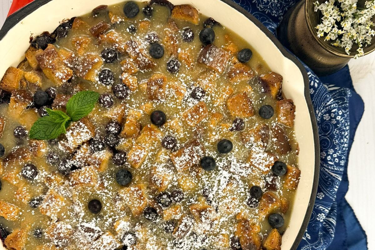 Louisiana blueberry bread pudding in an enameled cast iron skillet.