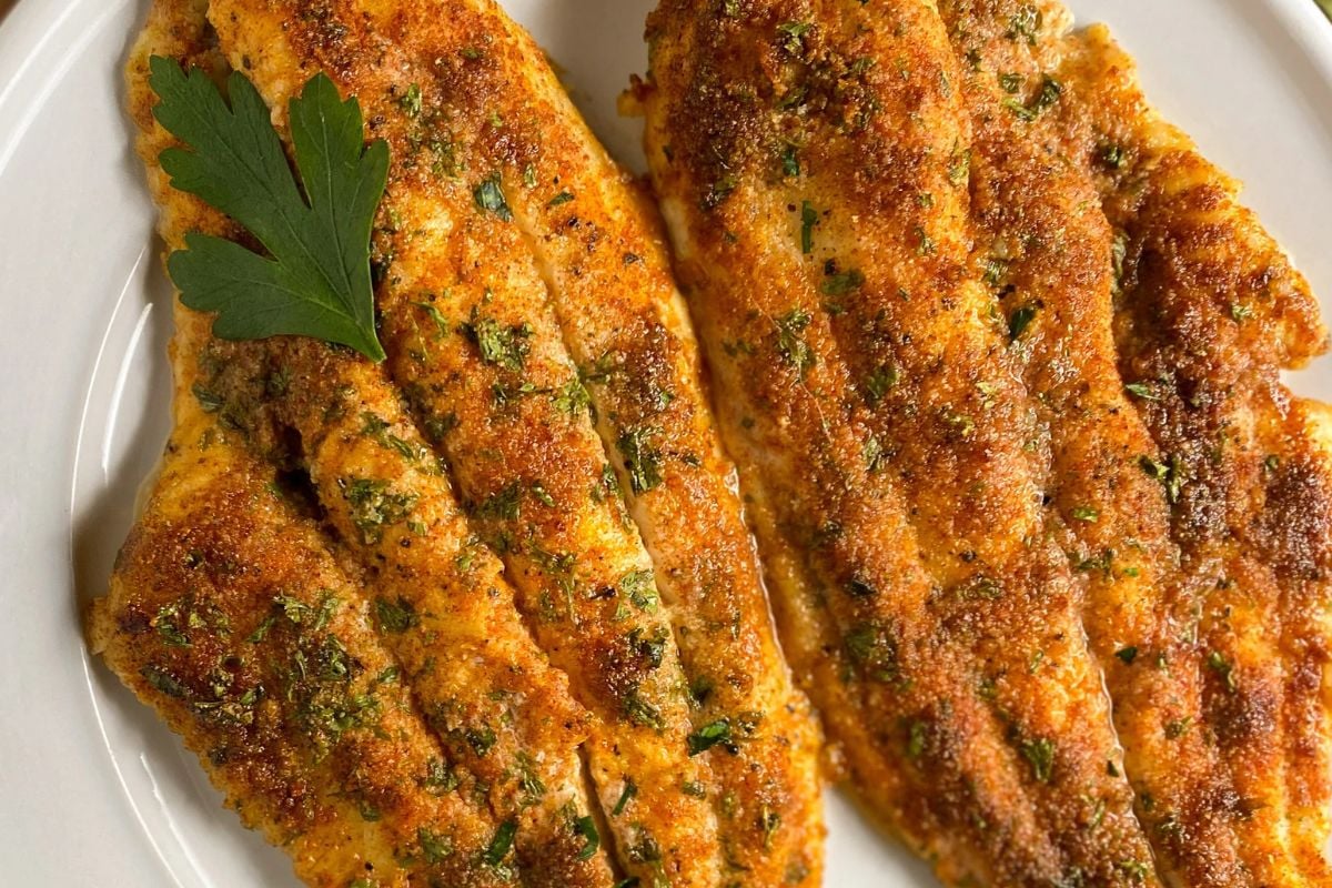 Two Cajun baked catfish fillets.