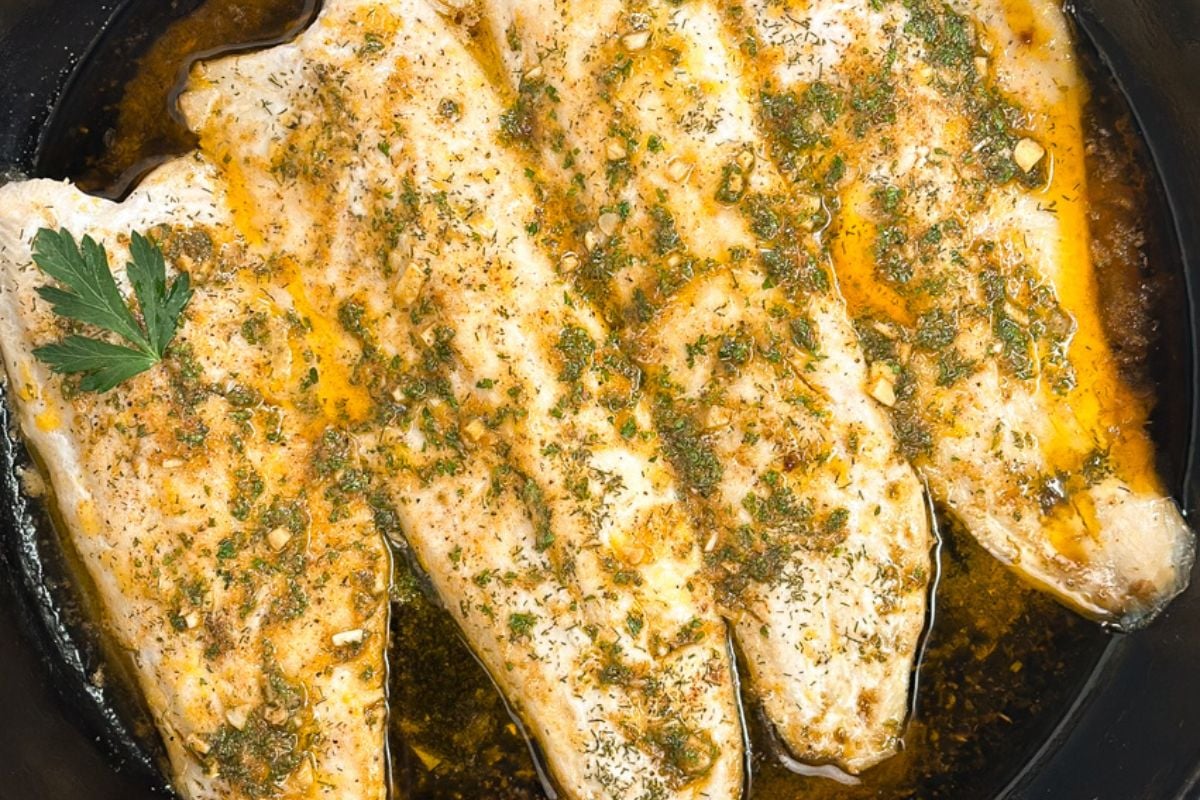 Baked rainbow trout with Cajun garlic butter sauce.