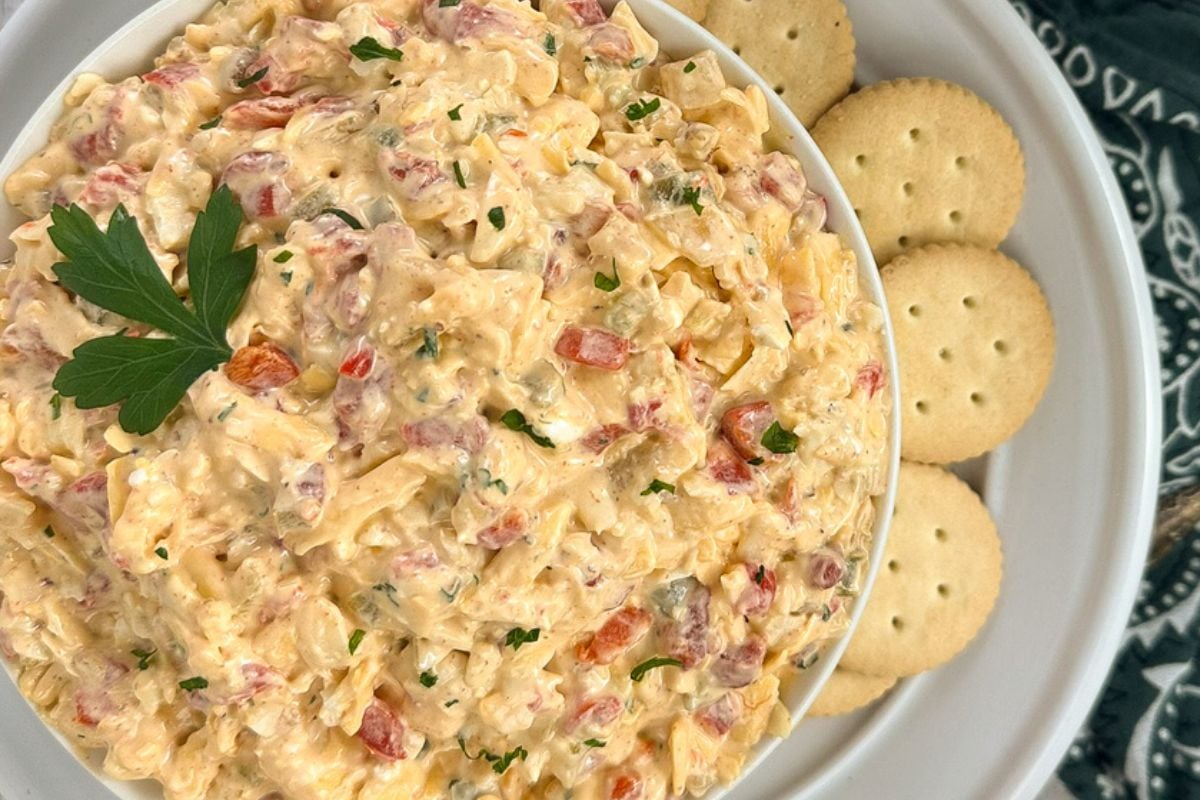 Cajun pimento cheese in a round white bowl. 