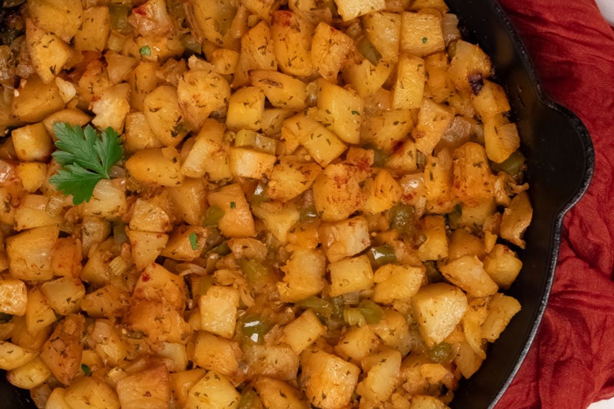 Cajun roasted potatoes in cast iron skillet.
