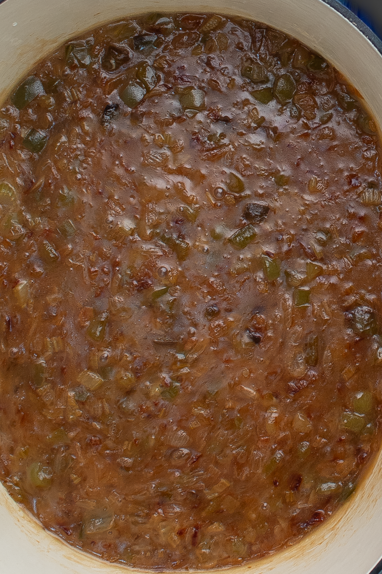 The Trinity Roux™ in a large white oval cast iron Dutch oven.