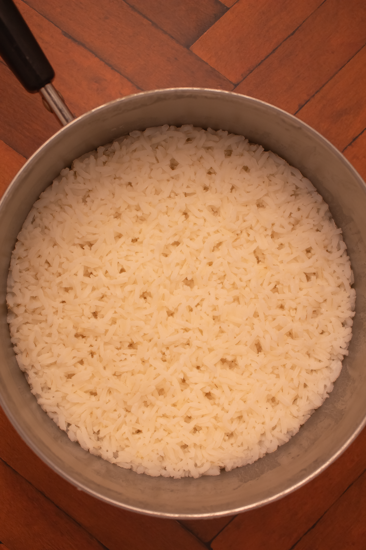 How to make rice on the stove final prep showing the cooked rice in a small pot.