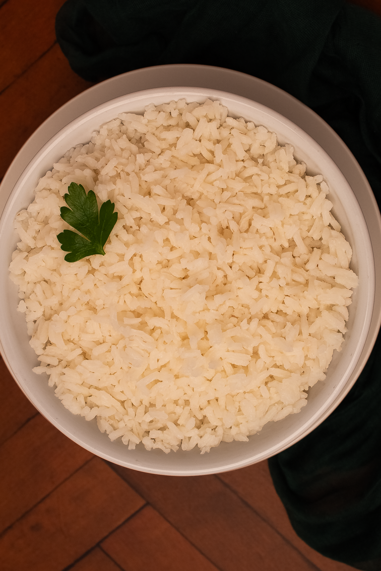 Cooked white rice in a round white bowl. 