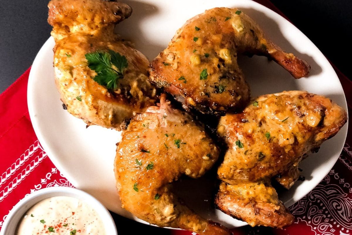 Cajun grilled chicken remoulade on an oval white serving platter. 
