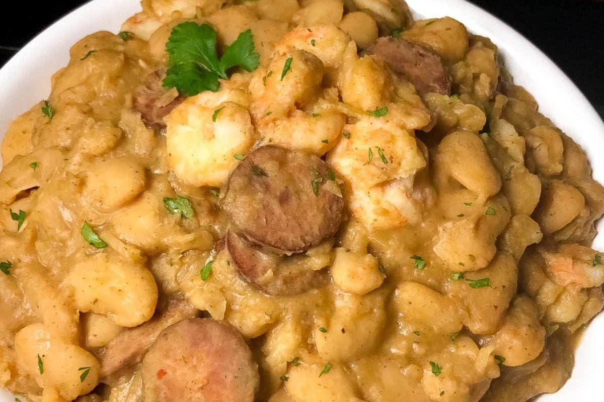 Closeup of Cajun butter beans with shrimp and sausage in a bowl.