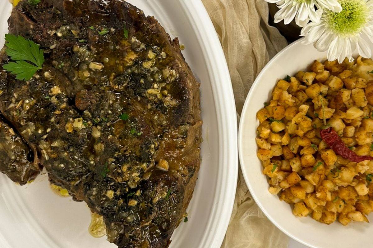Louisiana garlic-stuffed beef roast a white oval serving plate.