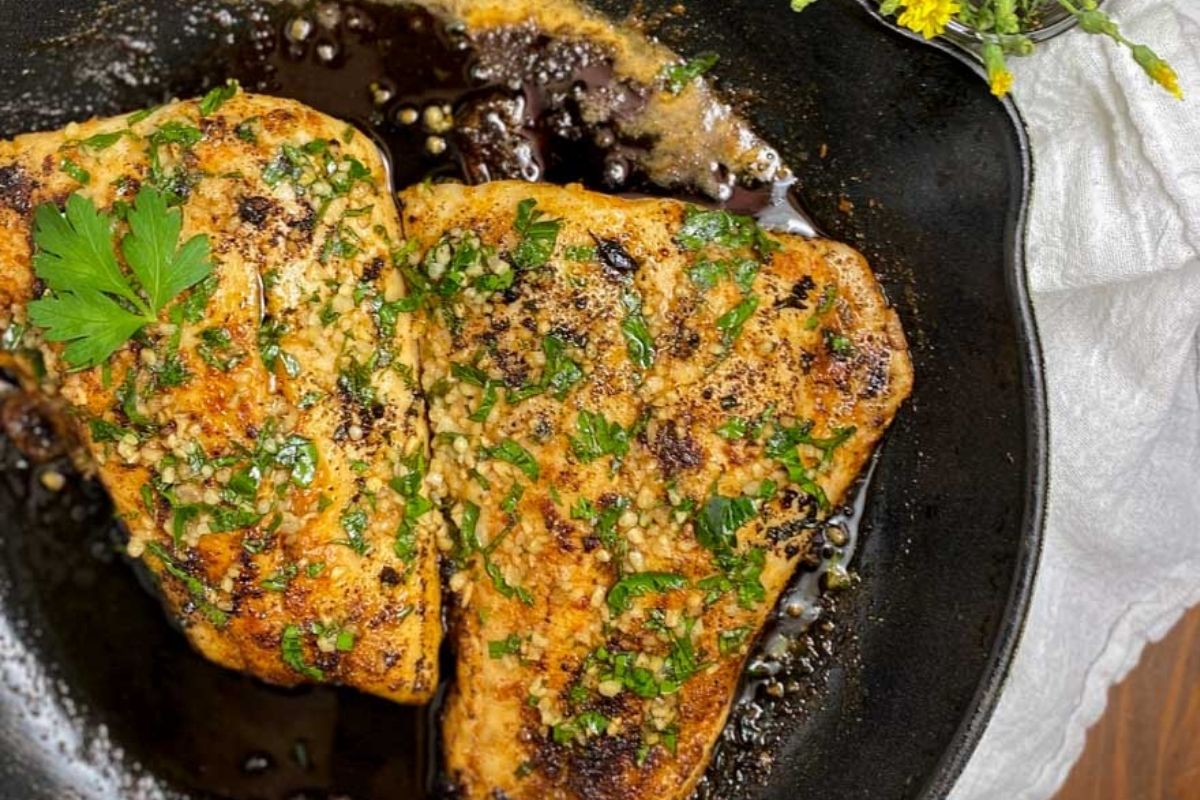 Pan seared snapper in a skillet.