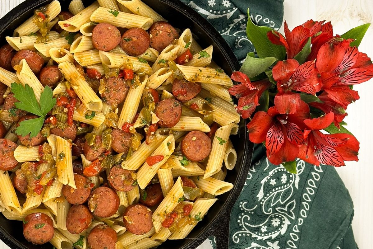 Cajun sausage pasta in a skillet.