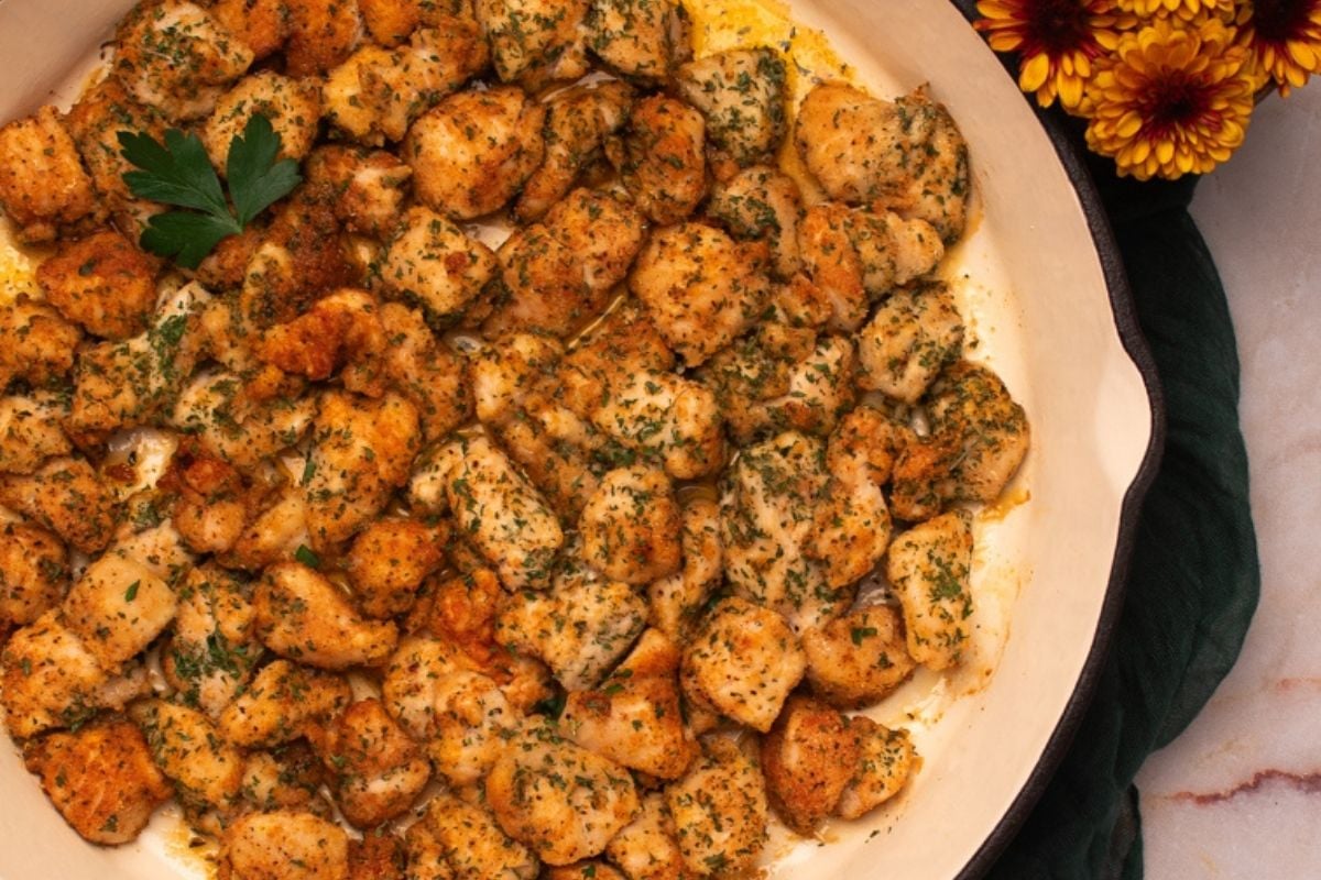 Cajun baked chicken bites in a skillet.