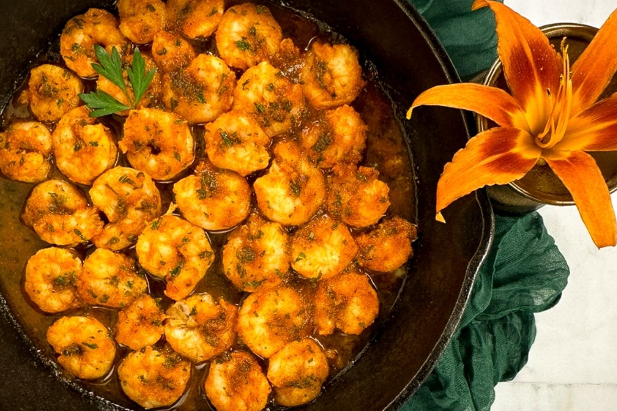 Cajun baked shrimp in a skillet.