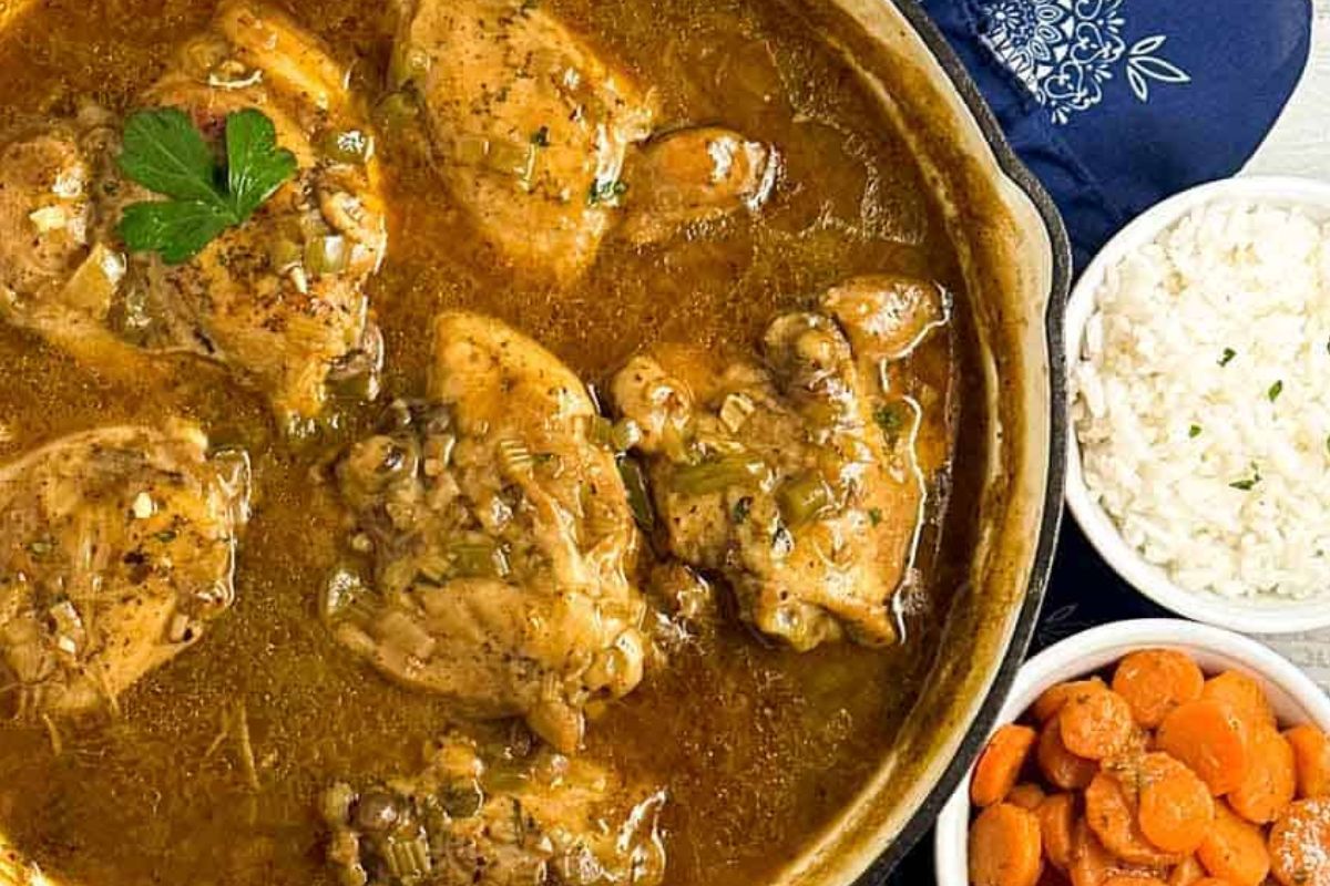 Cajun chicken fricassee in an enameled cast iron skillet.