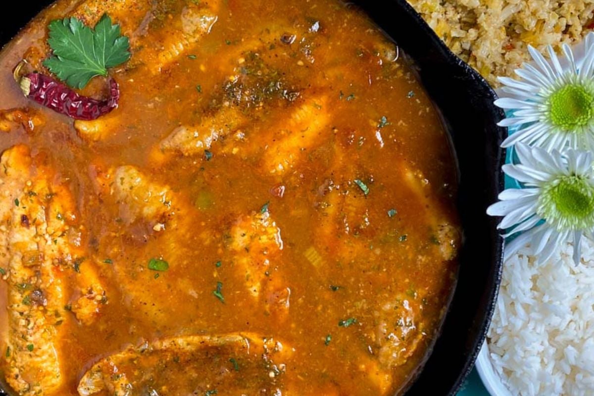 Catfish courtbouillon in a black cast iron skillet.