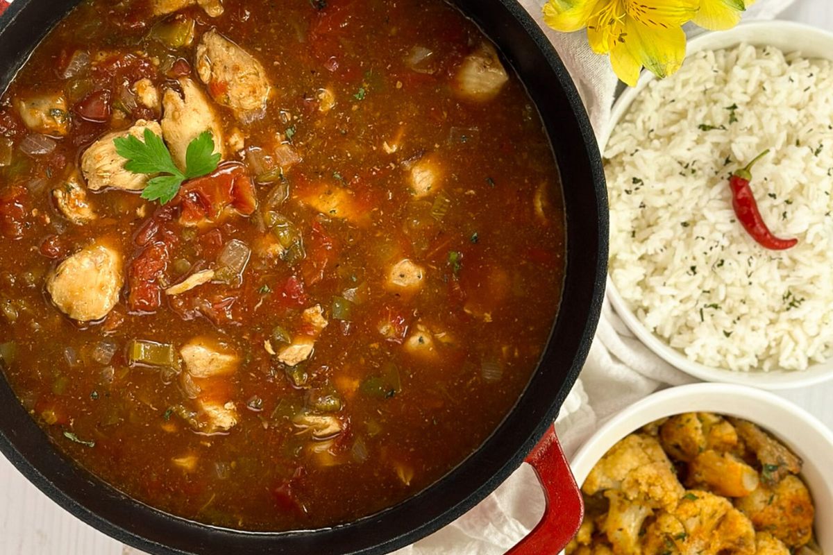 Chicken sauce piquante in a red enamled cast iron Dutch oven.
