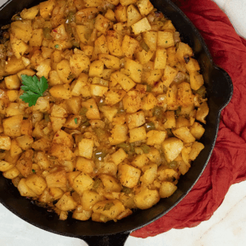 Cajun roasted potatoes in a black cast iron skillet.