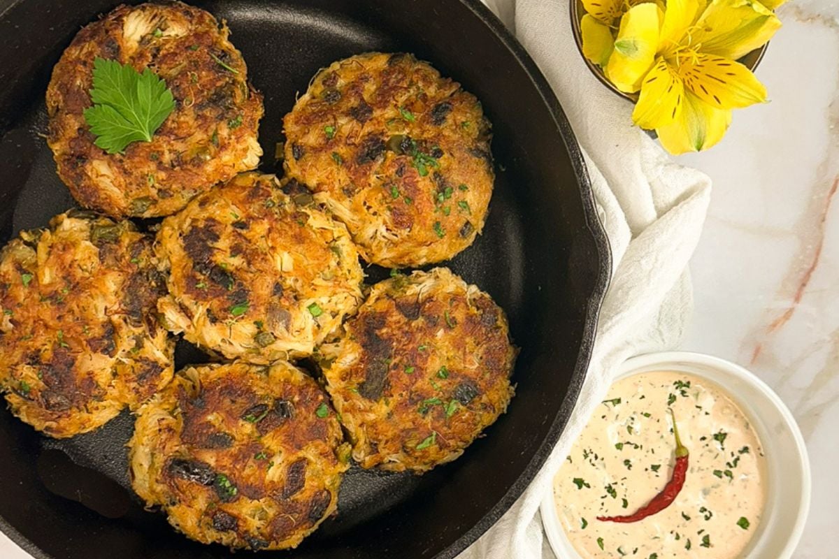 Cajun crab cakes in a black skillet.