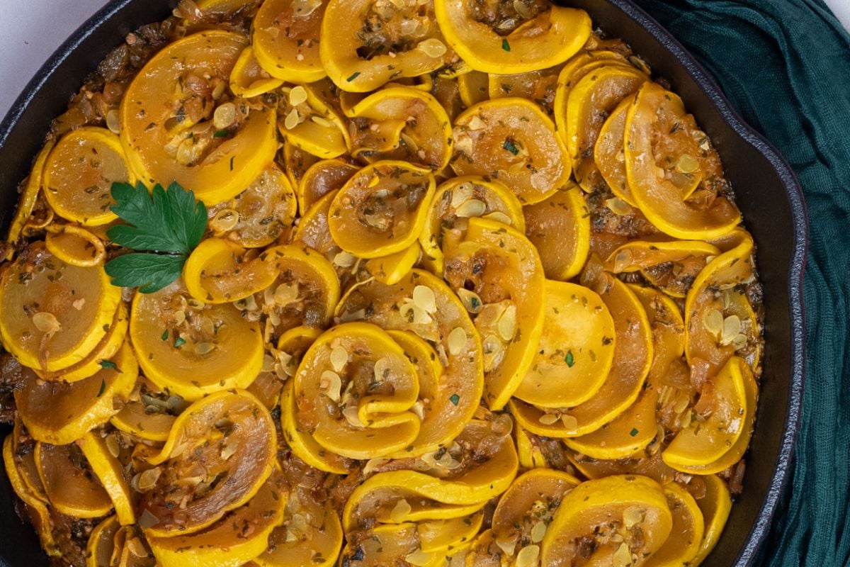 Cajun smothered squash in a skillet.