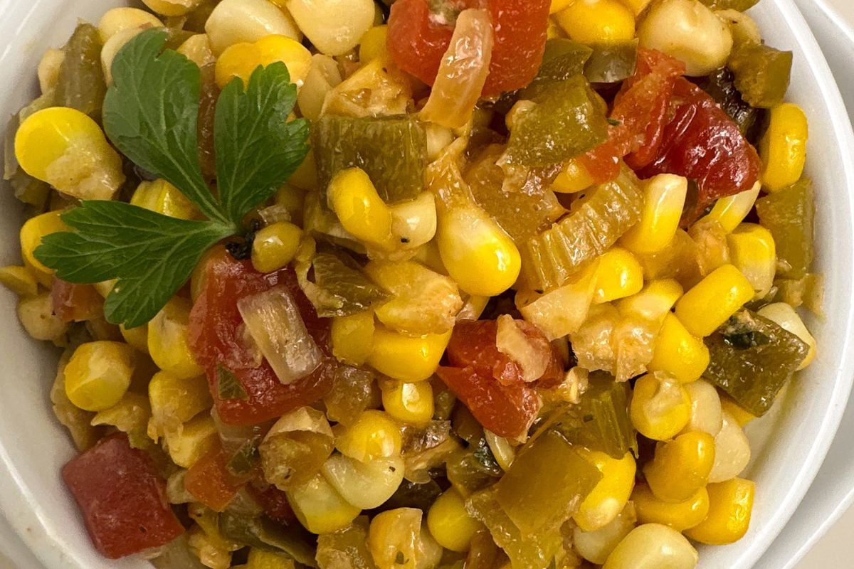 Corn maque choux in a round white bowl.