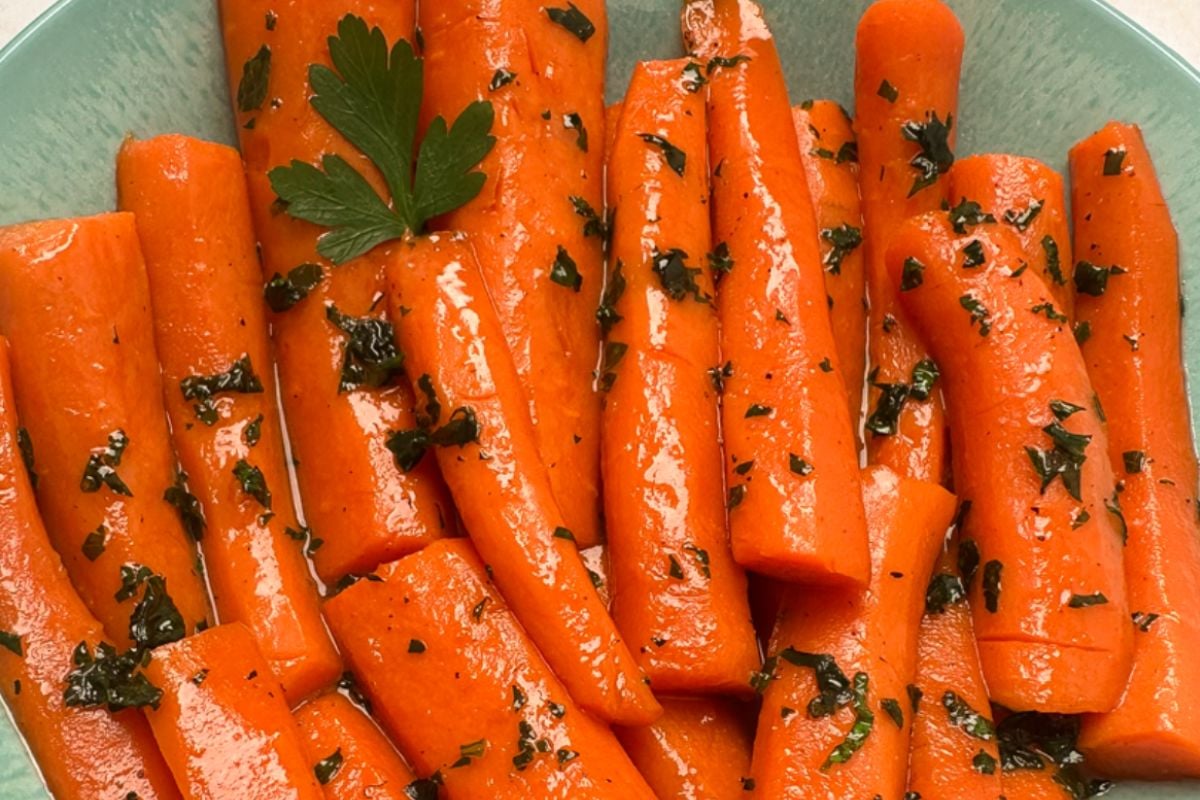 Maple glazed carrots in a light green bowl.