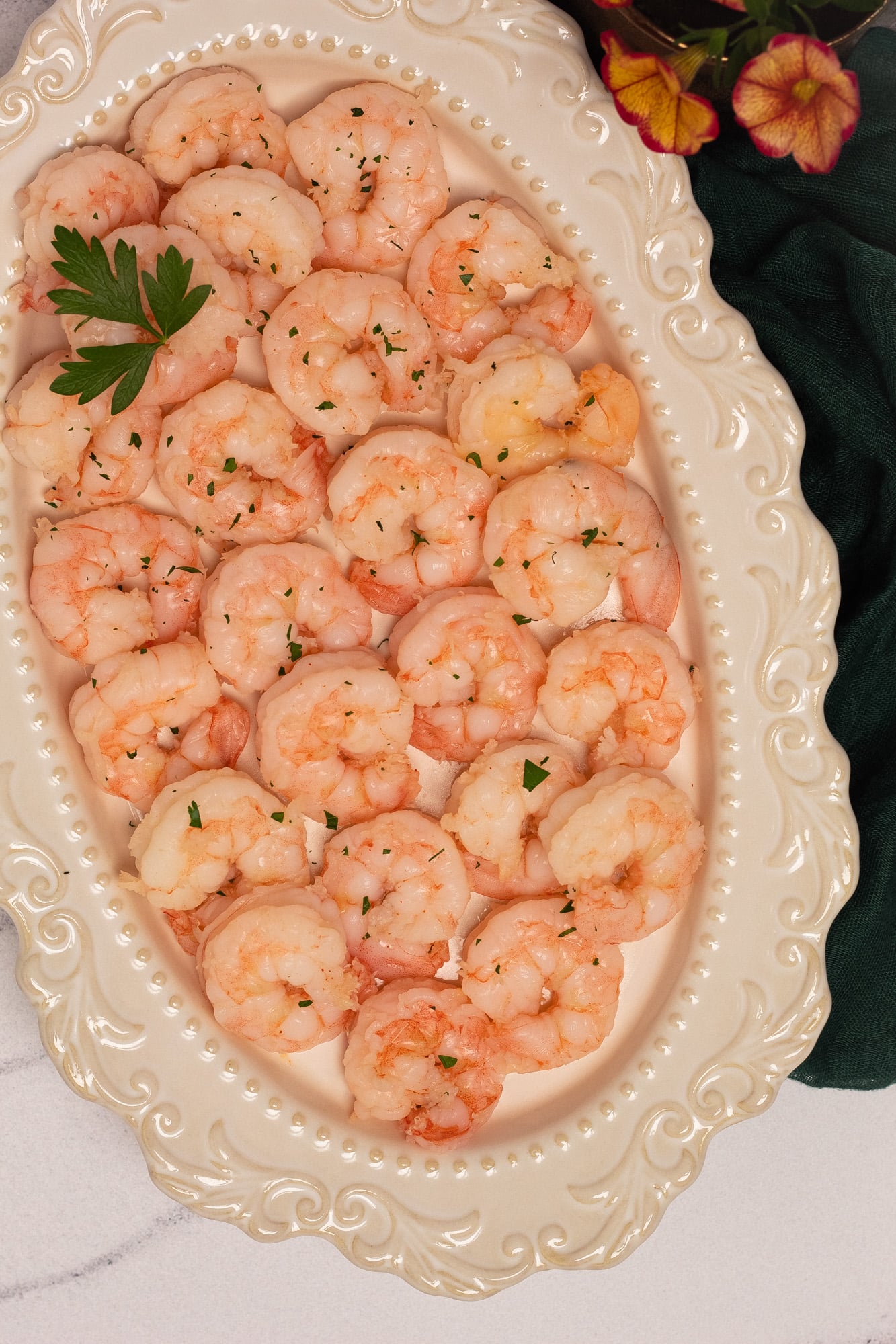  A closeup image of poached shrimp on a serving platter. 