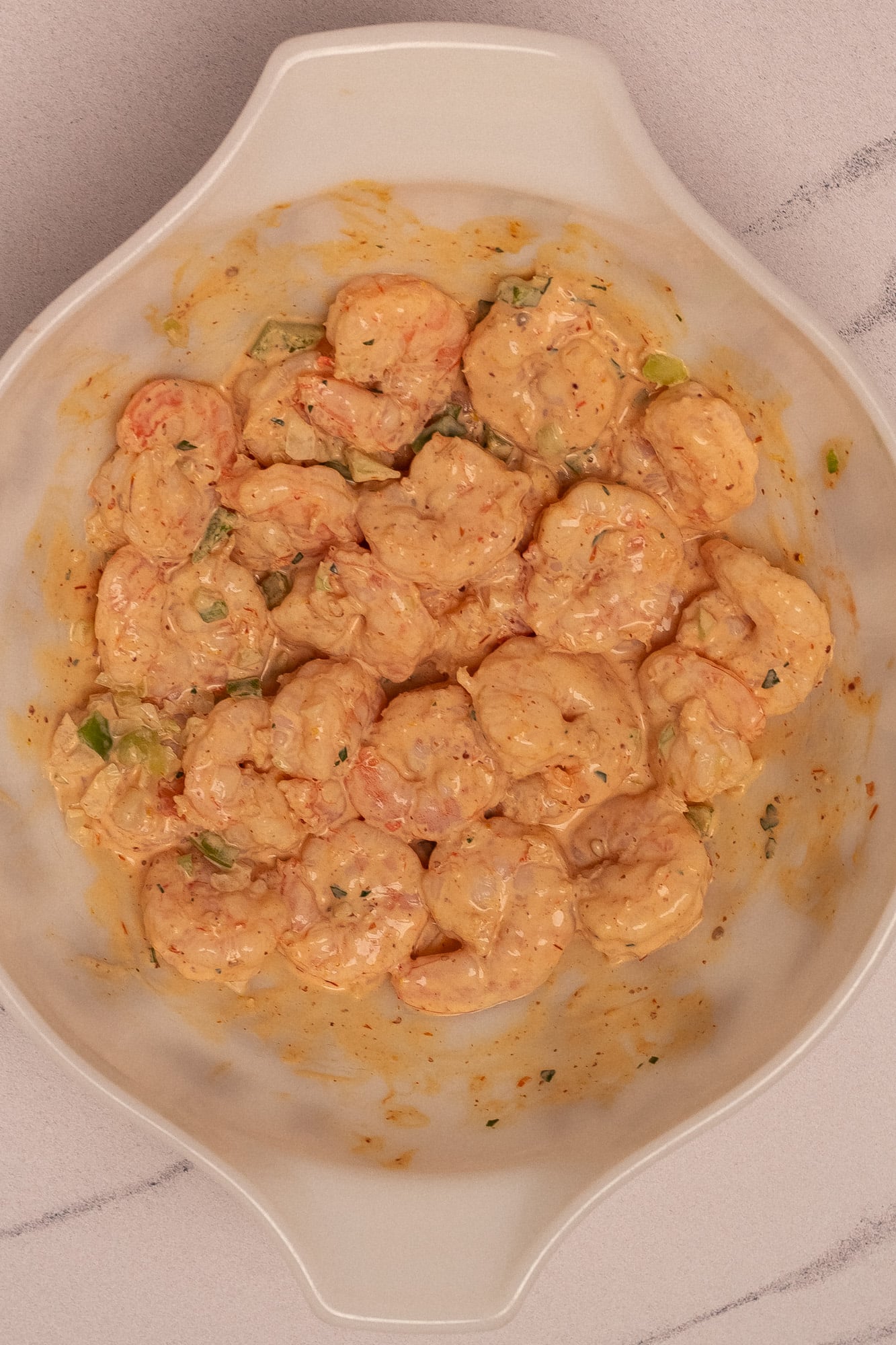 Freshly made poached shrimp with remoulade sauce in a bowl.