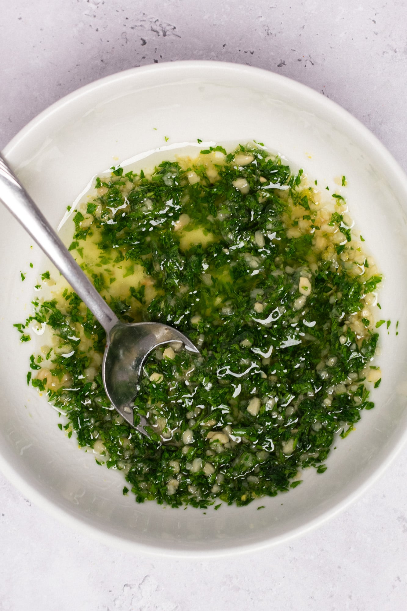 Lemon garlic butter sauce in a bowl with a spoon.