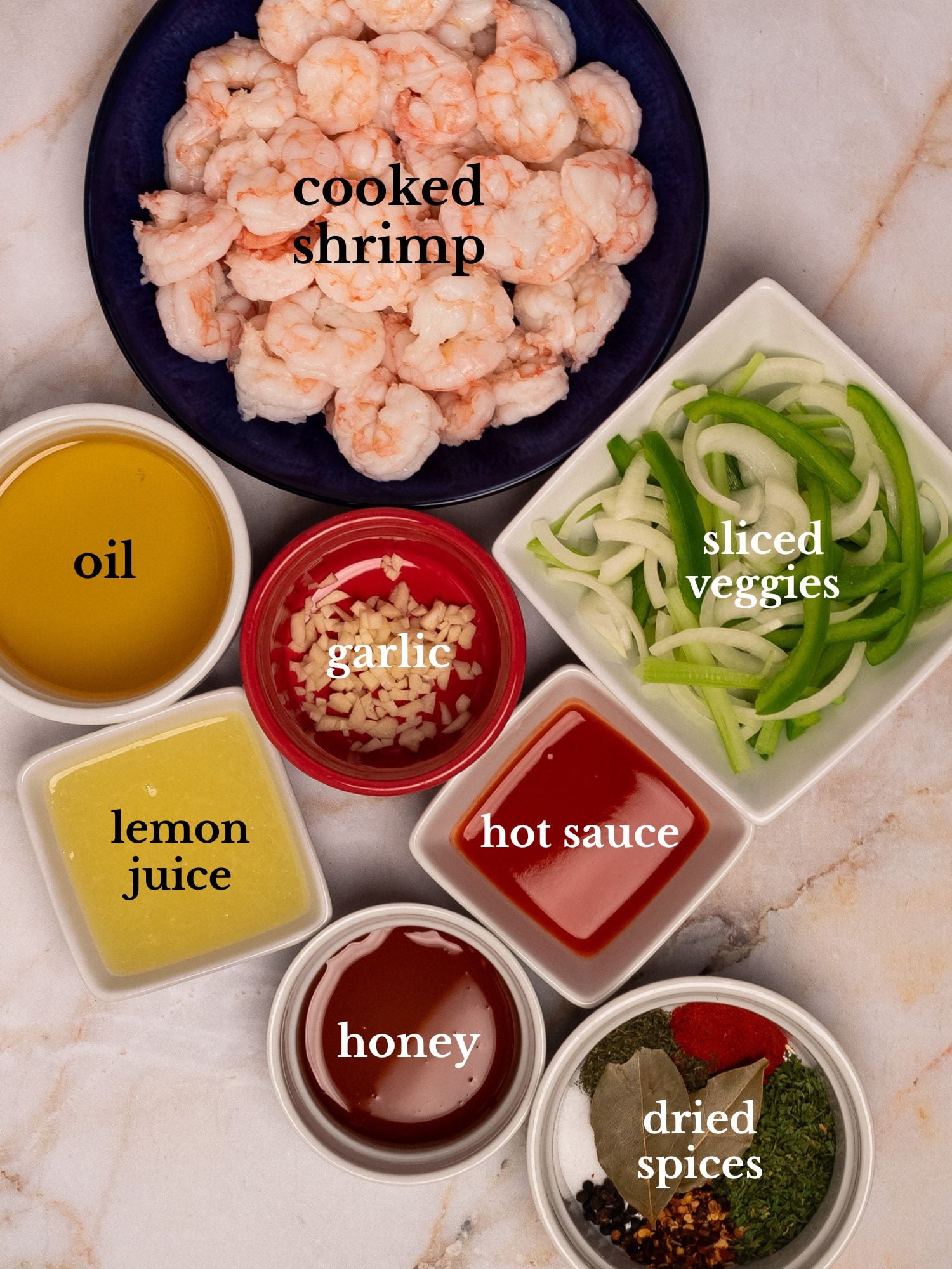 Labeled ingredients for pickled shrimp in bowls on a white marbled background.