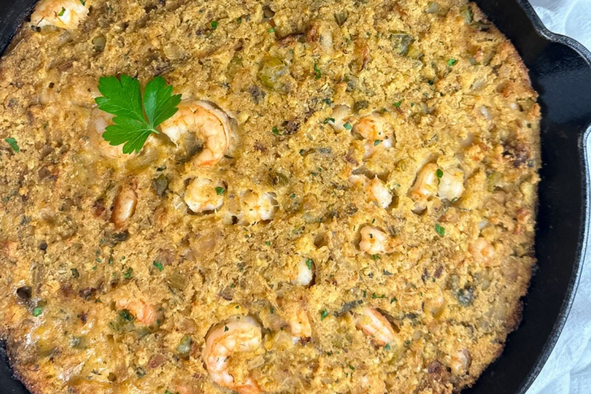 Cajun-style seafood dressing in a black cast iron skillet.