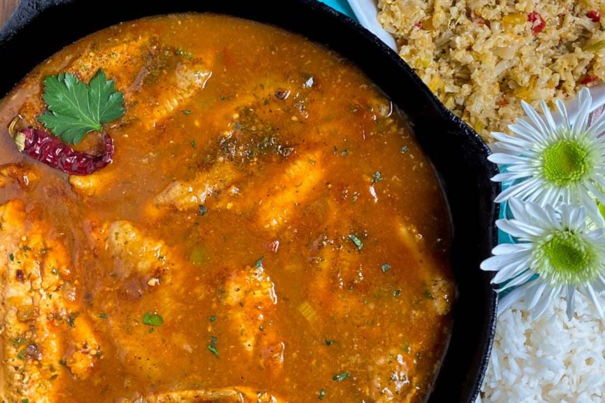 Catfish courtbouillon in a black cast iron skillet.