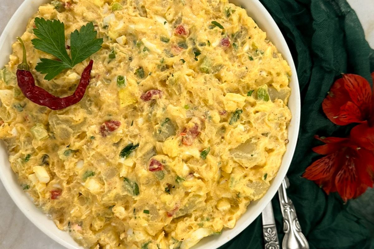 A closeup of Cajun potato salad in a white bowl. 