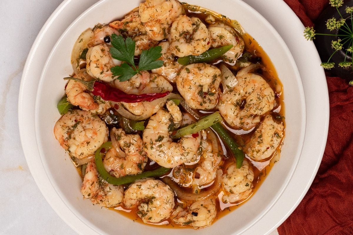 Cajun pickled shrimp in a round white bowl. 