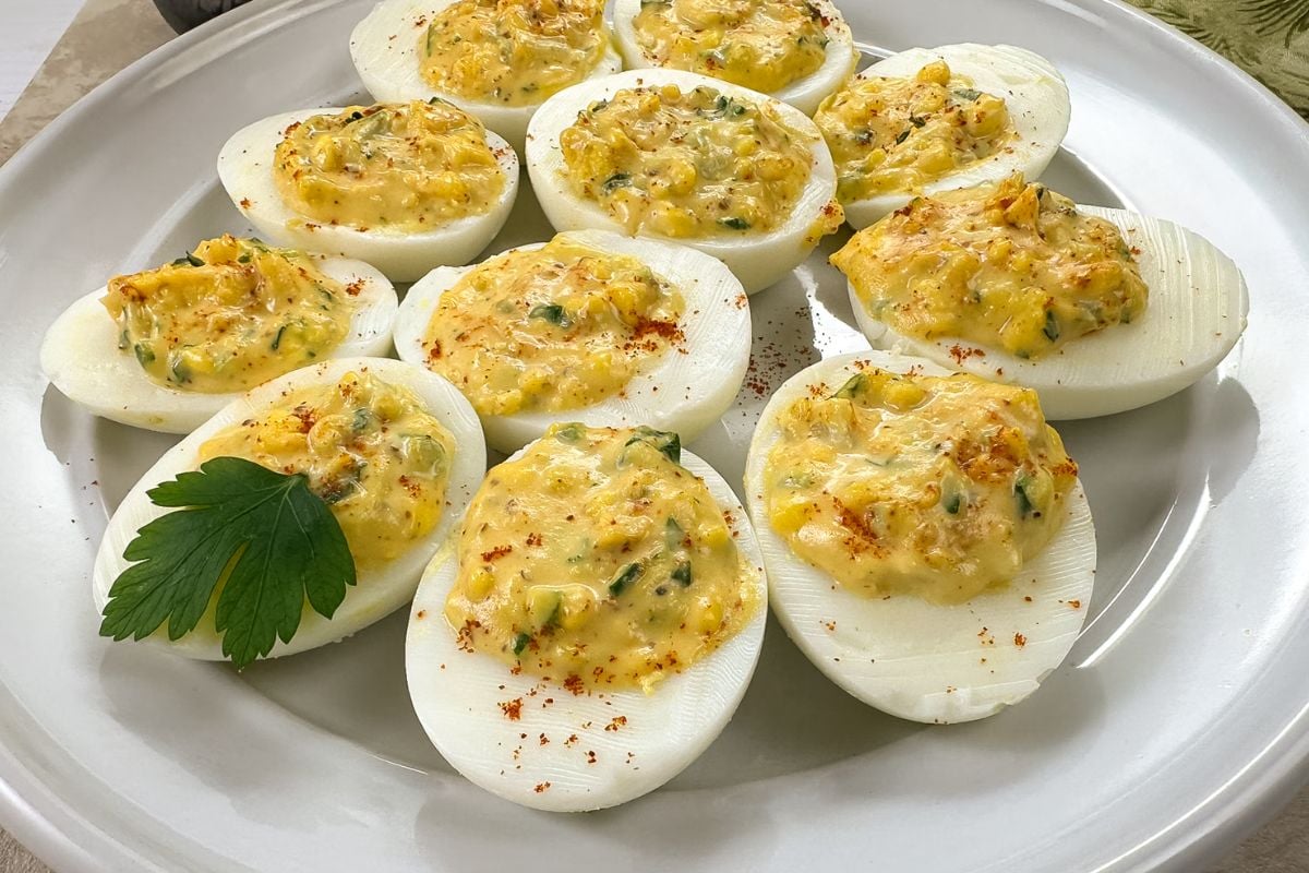 A closeup of Cajun deviled eggs on a white plate. 